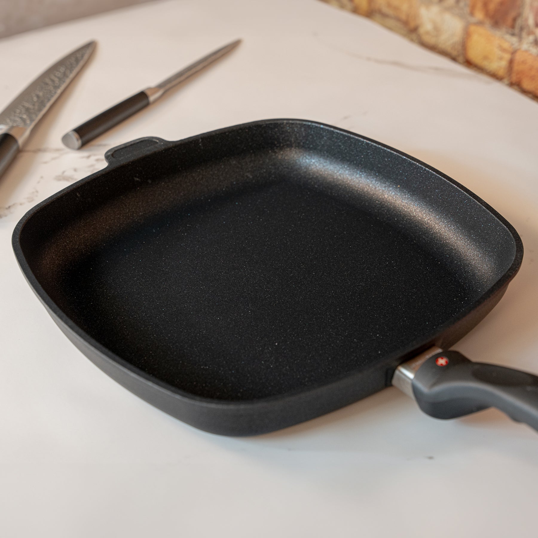 XD Nonstick 28 x 28 cm Square Fry Pan in used on marble kitchen counter