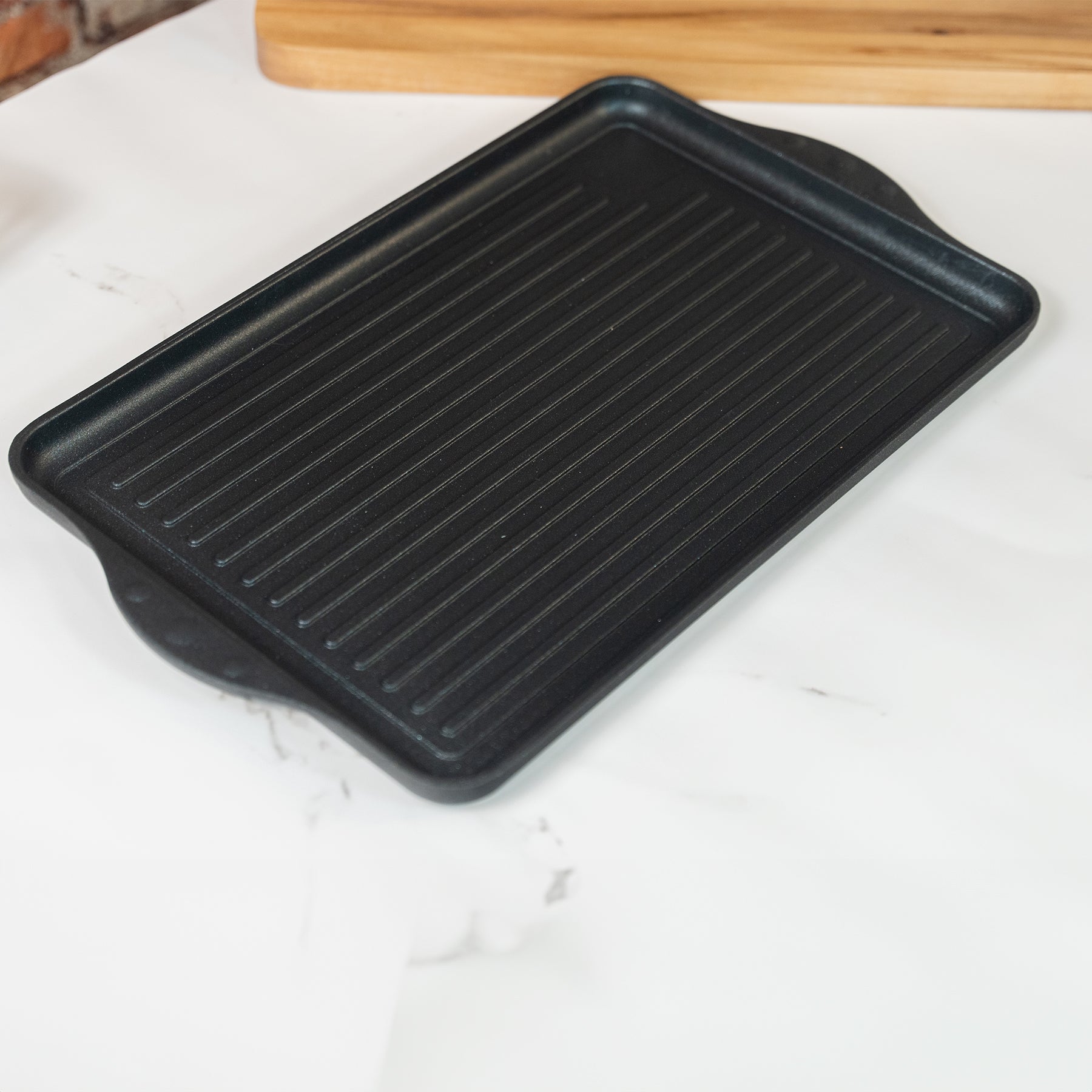 XD Nonstick 118 cm x 28 cm Double-Burner Grill in use on kitchen counter