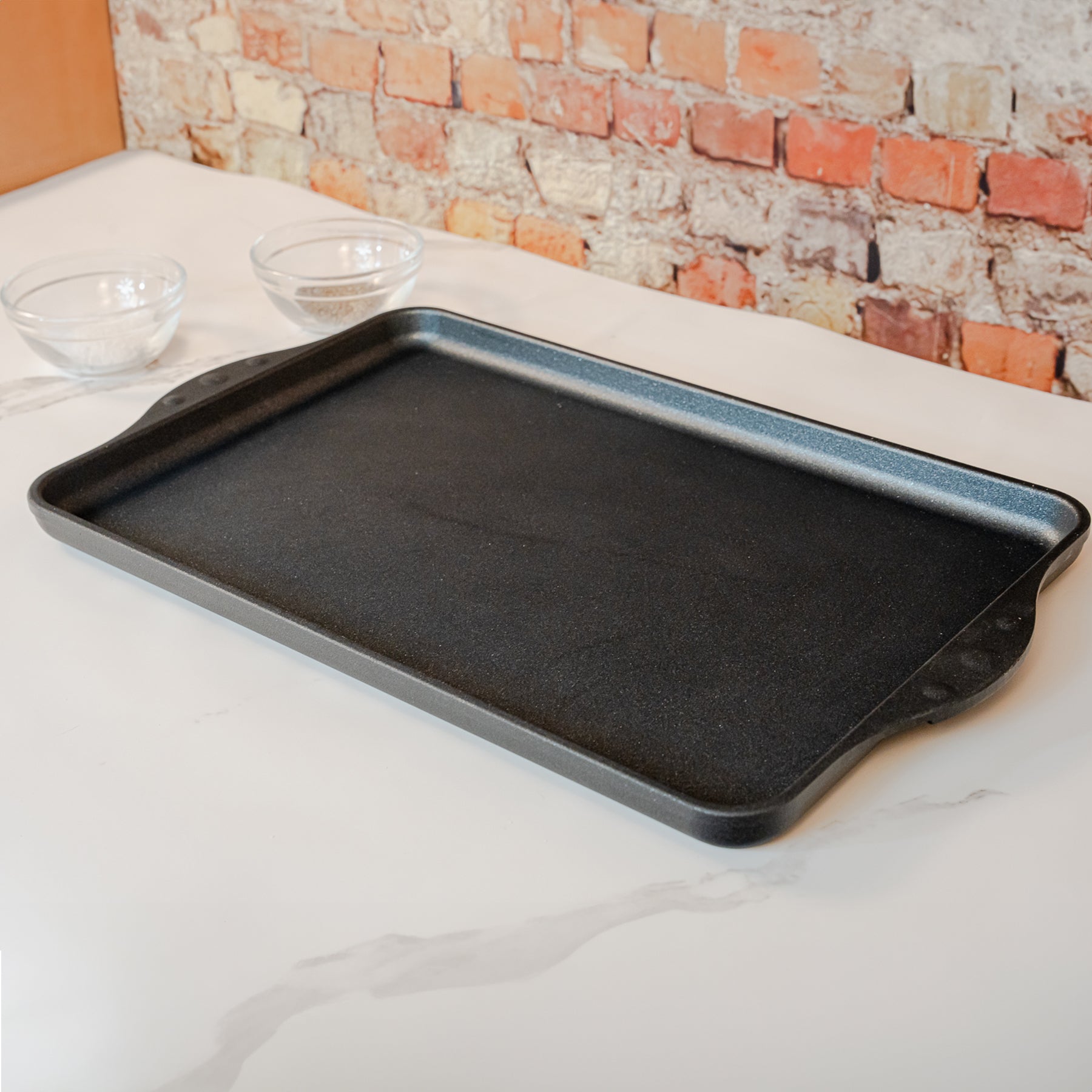 XD Nonstick 118 cm x 28 cm Double-Burner Griddle in use on white counter top