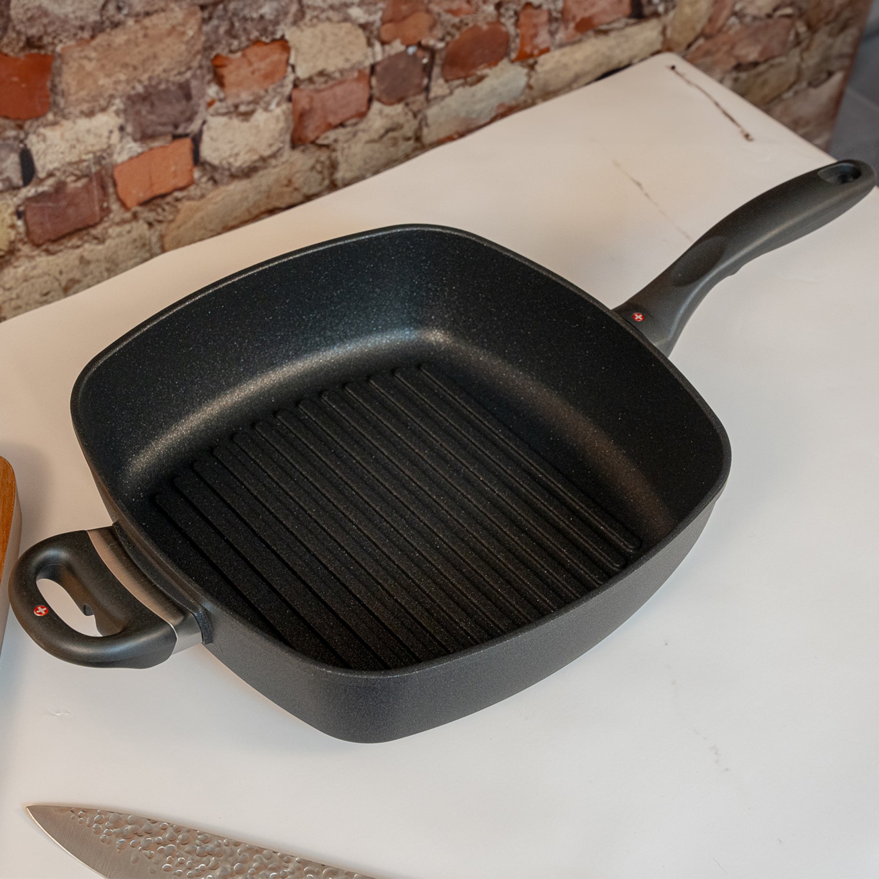 XD Nonstick 28 x 28 cm Deep Square Grill Pan in use on marble counter top