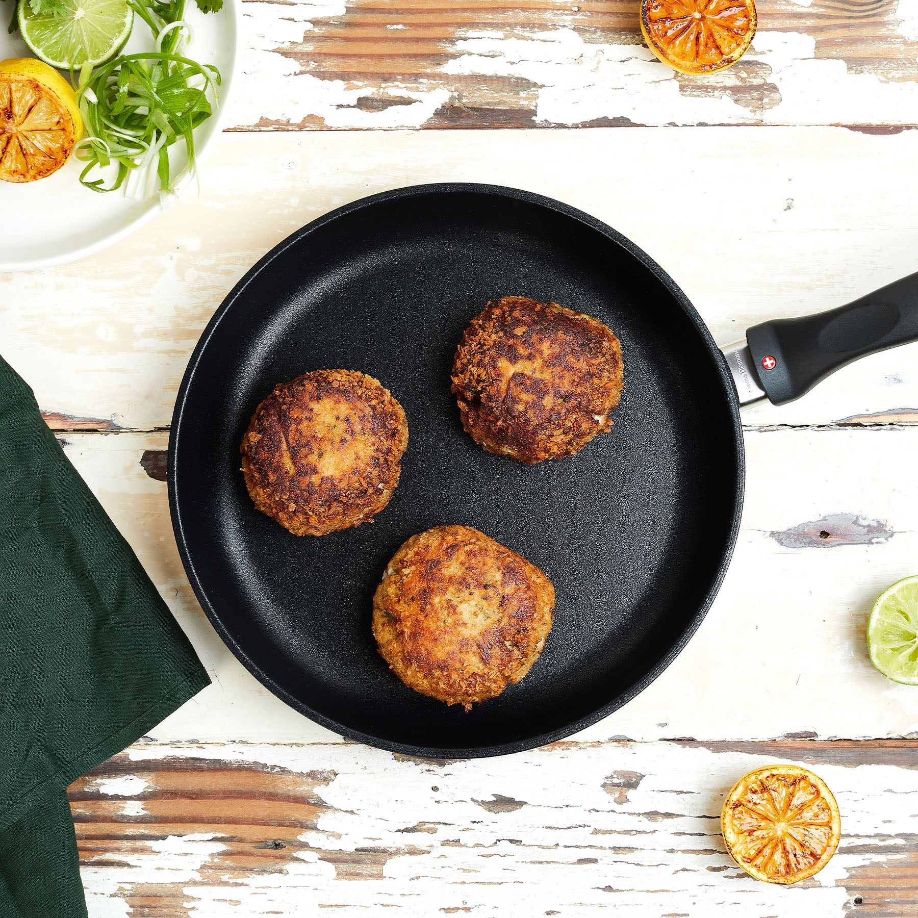 XD Nonstick Fry Pan with food in it on a wooden table - top view