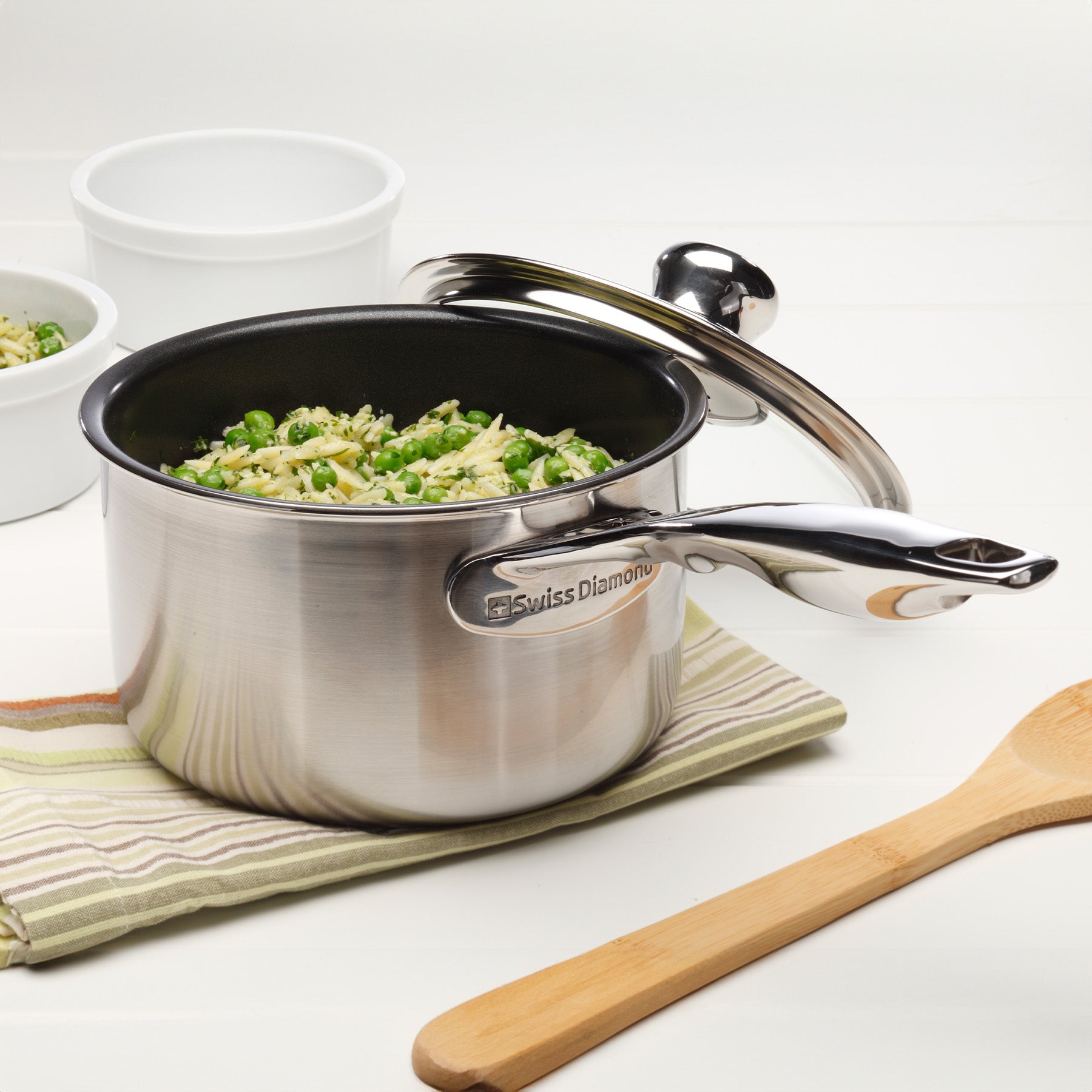 Nonstick Clad Saucepan with Glass Lid - Induction in use on kitchen counter