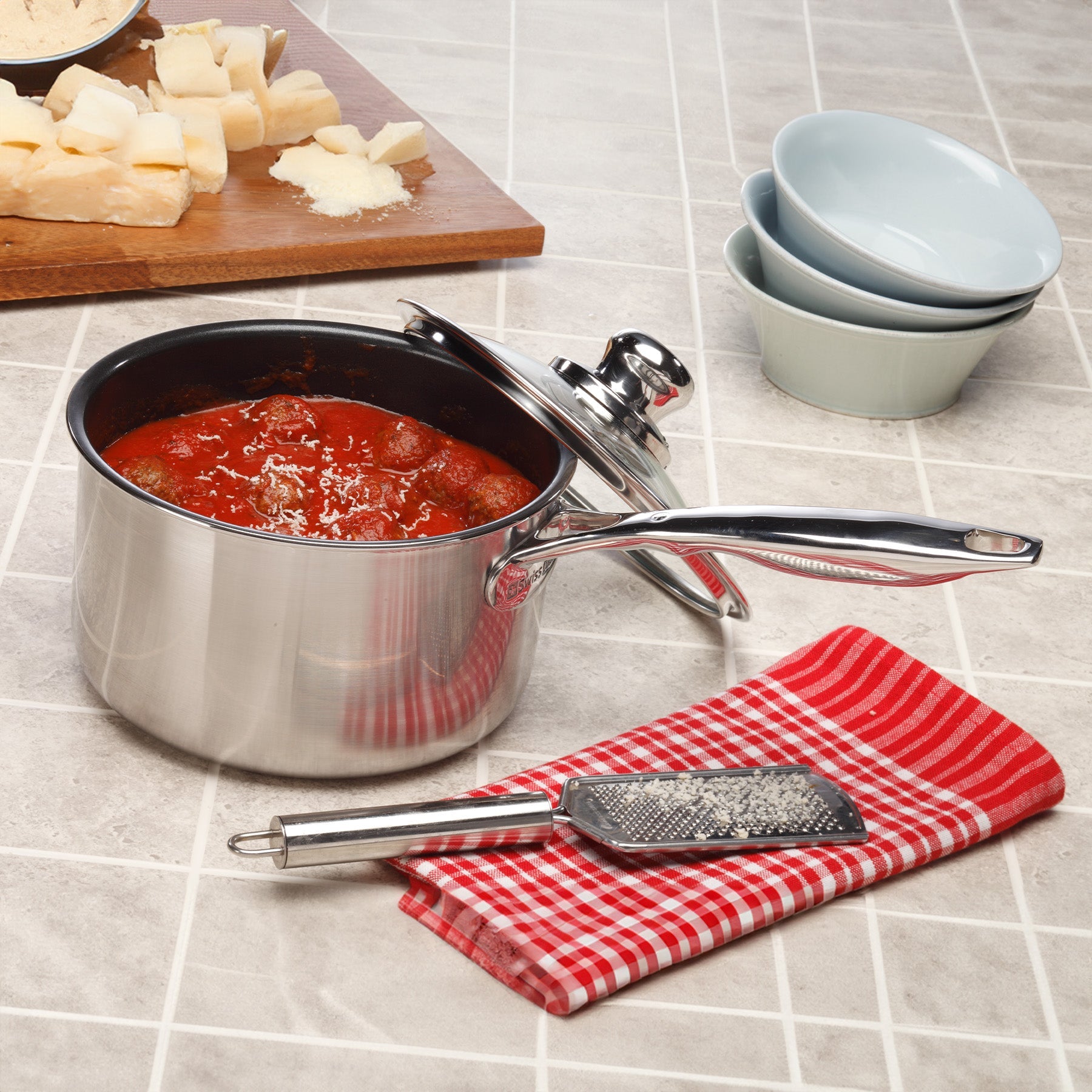 Nonstick Clad Saucepan with Glass Lid - Induction in use on kitchen counter