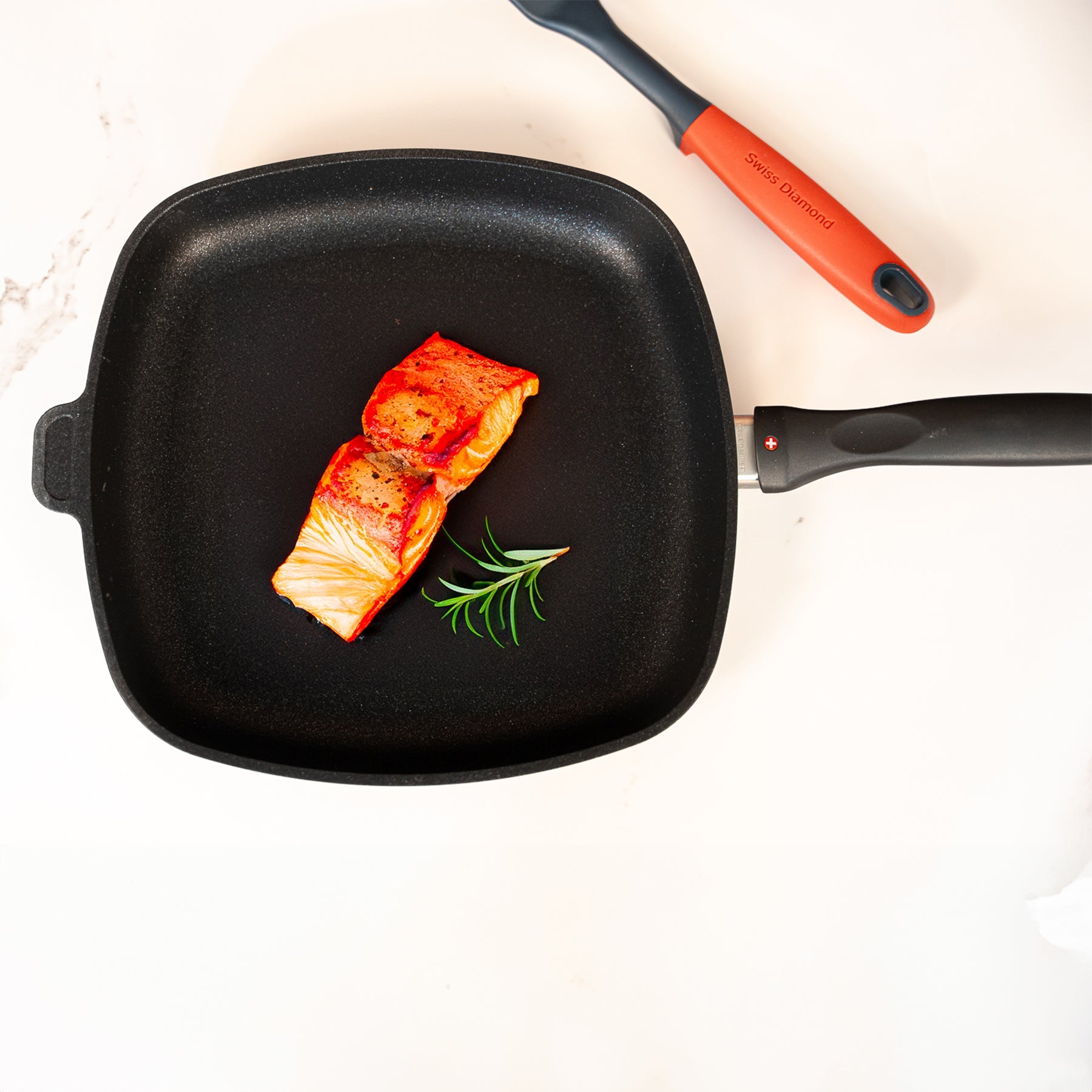 XD Nonstick 28 x 28 cm Square Fry Pan in use with cooked salmon on surface