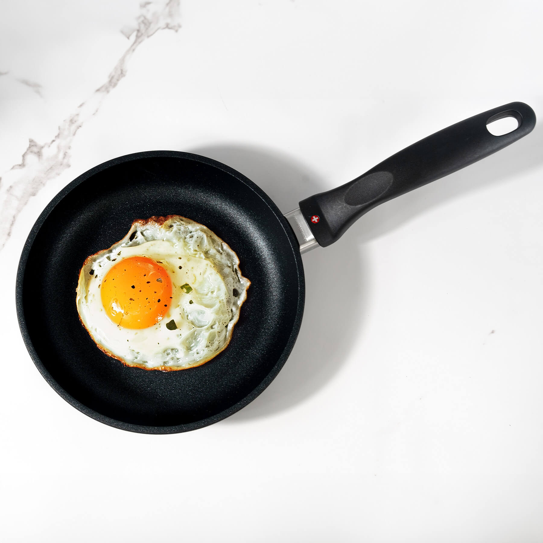 XD Nonstick Fry Pan top view with food inside on marble kitchen counter