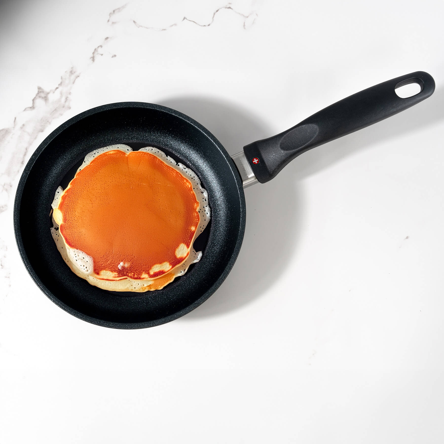 XD Nonstick Fry Pan - Induction top view with food inside on kitchen counter