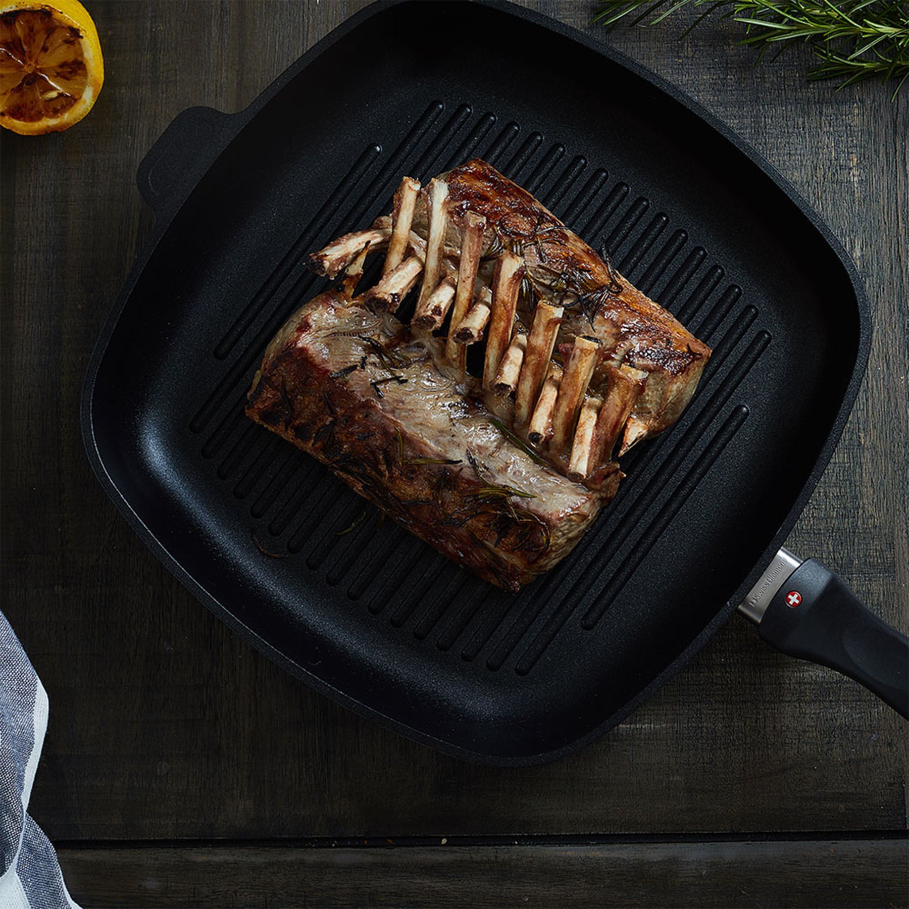 XD Nonstick Grill Pan with food in it on a wooden table - top view